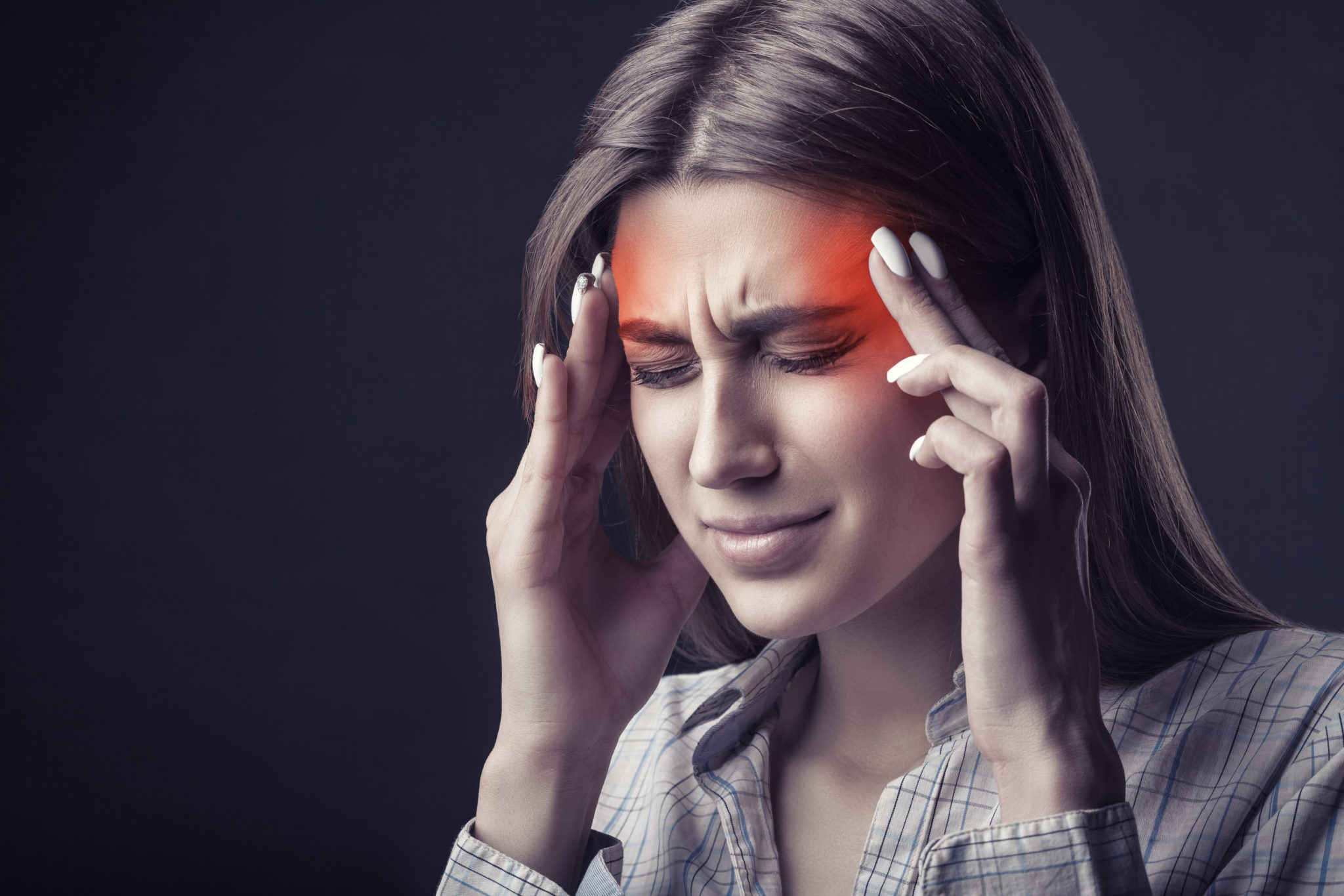 A woman with her hands on her head.