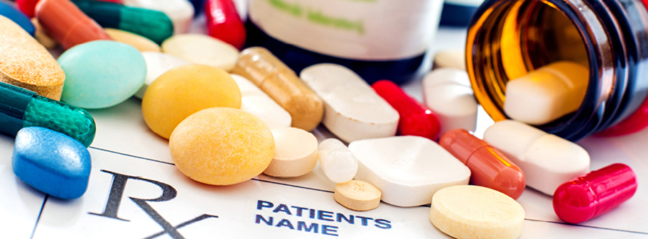 A table topped with pills and vitamin tablets.