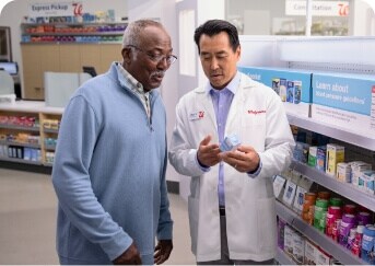 Two men in a pharmacy talking to each other.