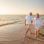 A couple of people walking on the beach