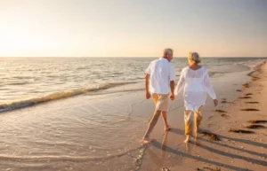 A couple of people walking on the beach