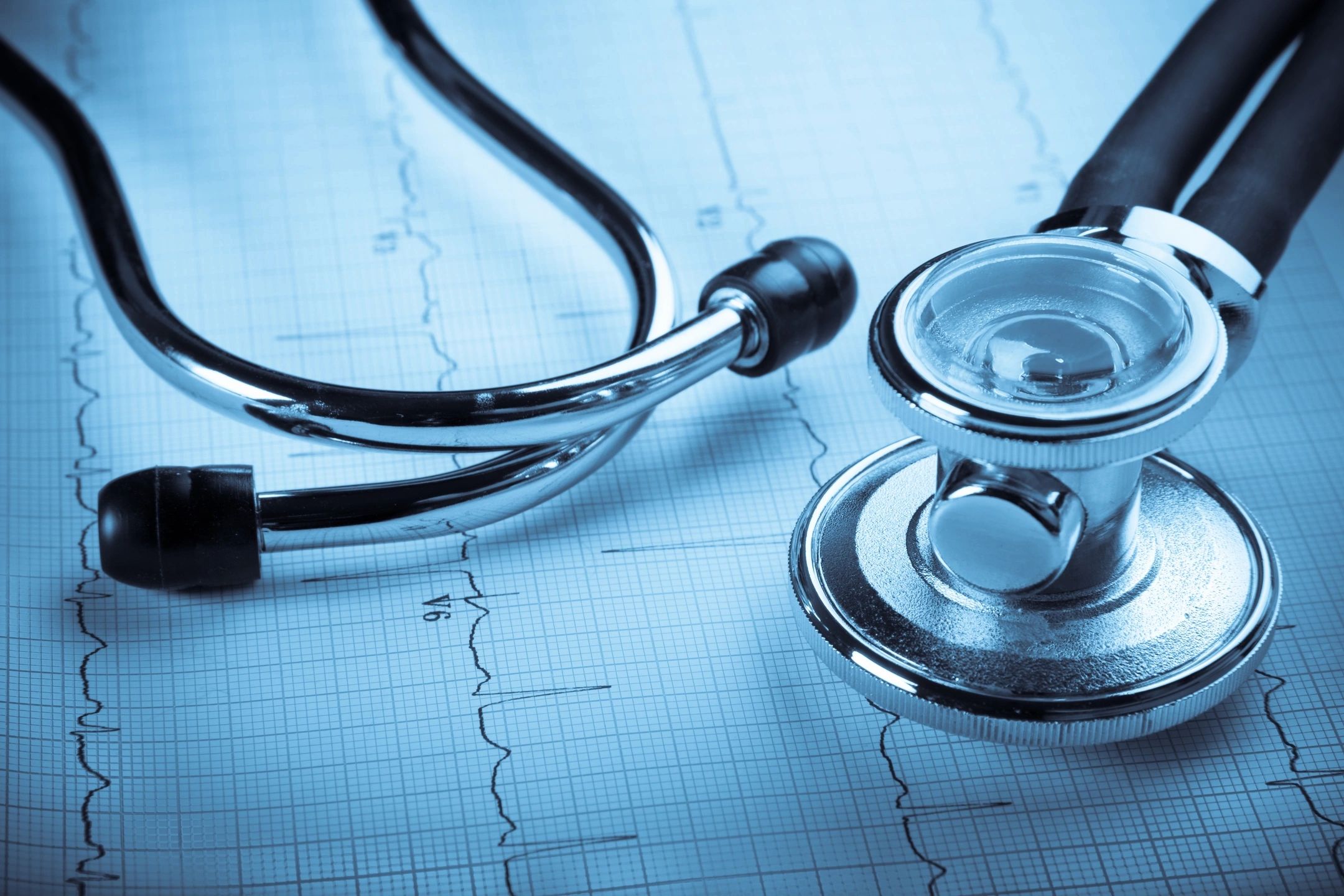 A stethoscope on top of an ecg chart used in insurance and retirement planning.